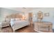 Spacious bedroom showcasing hardwood floors, soft lighting, and a decorative vanity at 4473 Gulf Of Mexico Dr, Longboat Key, FL 34228