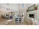 Open-concept kitchen and dining area featuring a cozy fireplace, providing an inviting space for Gathering gatherings and entertaining at 4473 Gulf Of Mexico Dr, Longboat Key, FL 34228