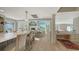 Open-concept kitchen flows into a dining area with views, complete with a cozy seating area and dedicated workspace at 4473 Gulf Of Mexico Dr, Longboat Key, FL 34228