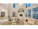 Dining room with fireplace, tall windows, high ceilings, and white trim at 4473 Gulf Of Mexico Dr, Longboat Key, FL 34228