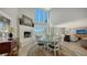 Elegant dining area with high ceilings, fireplace, water view, and natural light at 4473 Gulf Of Mexico Dr, Longboat Key, FL 34228