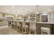 Bright kitchen featuring a large island with bar seating, stainless steel appliances, and elegant pendant lighting at 4473 Gulf Of Mexico Dr, Longboat Key, FL 34228