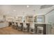 Large, modern kitchen with seating at the island and stainless steel appliances at 4473 Gulf Of Mexico Dr, Longboat Key, FL 34228