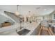 Spacious kitchen with large island, stainless steel sink, and stairs in background at 4473 Gulf Of Mexico Dr, Longboat Key, FL 34228