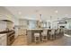 Spacious kitchen with white cabinetry, a large center island with bar seating, and stainless steel appliances at 4473 Gulf Of Mexico Dr, Longboat Key, FL 34228