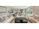 Bright and airy living room with white sofas, modern coffee tables, and an inviting fireplace at 4473 Gulf Of Mexico Dr, Longboat Key, FL 34228