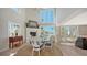 Elegant dining room with fireplace and stunning waterfront views through large windows at 4473 Gulf Of Mexico Dr, Longboat Key, FL 34228