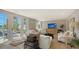 Bright living room features neutral decor and french doors leading to outdoor patio at 4473 Gulf Of Mexico Dr, Longboat Key, FL 34228