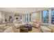 Spacious living room featuring comfortable seating, fireplace, and ample natural light at 4473 Gulf Of Mexico Dr, Longboat Key, FL 34228