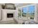 Cozy living room featuring a fireplace and expansive windows with beach views at 4473 Gulf Of Mexico Dr, Longboat Key, FL 34228