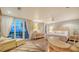 A spacious main bedroom that features an outdoor balcony, a sitting area, and hardwood floors at 4473 Gulf Of Mexico Dr, Longboat Key, FL 34228