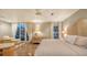 A spacious main bedroom that features an outdoor balcony, a sitting area, and hardwood floors at 4473 Gulf Of Mexico Dr, Longboat Key, FL 34228