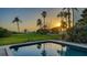 Backyard pool with calm, blue water and ocean views at sunset at 4473 Gulf Of Mexico Dr, Longboat Key, FL 34228