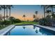 Stunning pool view surrounded by tropical plants at 4473 Gulf Of Mexico Dr, Longboat Key, FL 34228