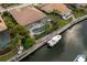 Backyard view of waterfront home with private pool and dock with boat at 4721 Mainsail Drive, Bradenton, FL 34208