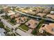 Breathtaking aerial view of luxury homes lining a canal, showcasing a waterfront community with lush landscaping and private docks at 4721 Mainsail Drive, Bradenton, FL 34208