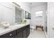 Bright bathroom featuring a granite-topped vanity, framed mirror and glass shower at 4721 Mainsail Drive, Bradenton, FL 34208