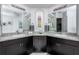 Bathroom with double vanity, granite countertops, and framed mirrors at 4721 Mainsail Drive, Bradenton, FL 34208