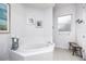 Bright bathroom featuring a soaking tub, large window, and white tile at 4721 Mainsail Drive, Bradenton, FL 34208