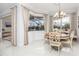 Bright dining room with a chandelier, large windows and views of the lanai at 4721 Mainsail Drive, Bradenton, FL 34208