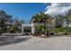 Elegant community entrance gate, beautifully landscaped with palm trees and manicured grounds at 4721 Mainsail Drive, Bradenton, FL 34208