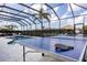 Fun screened-in outdoor recreation area with pool and ping pong tables, perfect for entertaining and enjoying the sunshine at 4721 Mainsail Drive, Bradenton, FL 34208