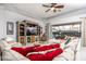 Comfortable living room featuring a large sofa, entertainment center, and sliding glass doors at 4721 Mainsail Drive, Bradenton, FL 34208