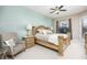 Main bedroom featuring a decorative bed frame, ceiling fan, and view of the pool at 4721 Mainsail Drive, Bradenton, FL 34208