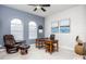 Office featuring a desk, a leather recliner, arched windows, and accent lighting at 4721 Mainsail Drive, Bradenton, FL 34208