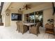 Covered patio with ceiling fan, TV, and dining table at 4721 Mainsail Drive, Bradenton, FL 34208