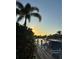 Waterfront view with private boat dockage at sunset, providing a relaxing coastal lifestyle at 4721 Mainsail Drive, Bradenton, FL 34208