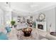 Open-concept living room with a fireplace, neutral color palette, and seamless flow into the kitchen area at 4805 Heinman Cv, Palmetto, FL 34221