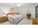 Cozy bedroom with a bed dressed in a patterned quilt and light wood flooring at 6650 Schooner Bay Cir # 6650, Sarasota, FL 34231