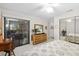 Cozy bedroom featuring sliding glass door, woven dresser, and mirrored closet at 6650 Schooner Bay Cir # 6650, Sarasota, FL 34231