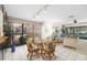 Bright dining area with large windows offering scenic views, complemented by a glass table and patterned chairs at 6650 Schooner Bay Cir # 6650, Sarasota, FL 34231