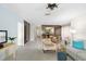 Open-concept living room with tiled floors, comfortable seating, and seamless flow into the dining and kitchen areas at 6650 Schooner Bay Cir # 6650, Sarasota, FL 34231