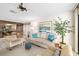 Inviting living room with comfortable seating, a ceiling fan, and a view into the adjacent dining area at 6650 Schooner Bay Cir # 6650, Sarasota, FL 34231