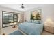 Serene main bedroom with a sliding glass door to the lanai, a comfortable bed, and tasteful decor at 6650 Schooner Bay Cir # 6650, Sarasota, FL 34231