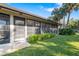 Enclosed patio with screens, lush landscaping, and a well-manicured lawn at 6650 Schooner Bay Cir # 6650, Sarasota, FL 34231