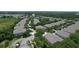 Expansive aerial view showcasing a vibrant residential community nestled amidst lush greenery and mature trees at 6768 Breezy Palm Dr, Riverview, FL 33578
