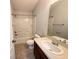 Bathroom offering a single sink vanity, bathtub with shower, and ceramic tile flooring at 6768 Breezy Palm Dr, Riverview, FL 33578