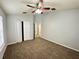 Neutral bedroom featuring carpeting, ceiling fan and bi-fold closet doors at 6768 Breezy Palm Dr, Riverview, FL 33578
