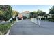View of the gated entrance to the property with security features and well-maintained landscaping at 6768 Breezy Palm Dr, Riverview, FL 33578