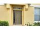Inviting front entrance, showcasing the front door flanked by lush greenery, and a sunny facade at 6768 Breezy Palm Dr, Riverview, FL 33578