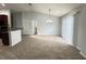 Inviting living room featuring neutral tones, plush carpet, and stylish lighting at 6768 Breezy Palm Dr, Riverview, FL 33578