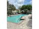 Community pool featuring lounge chairs, fencing, and clear blue water at 6768 Breezy Palm Dr, Riverview, FL 33578