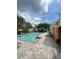 Community pool featuring a paved deck, lounge chairs, and trees for shade on a bright sunny day at 6768 Breezy Palm Dr, Riverview, FL 33578