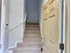 Carpeted stairway leading to the upper level of the home, with a front door providing convenient access at 6768 Breezy Palm Dr, Riverview, FL 33578