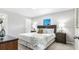 Calming main bedroom with a tufted headboard, neutral colors, and cozy bedding, next to the bedside tables at 6885 Americana Ave, North Port, FL 34291