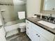 Well-lit bathroom with granite vanity, decorative mirror, and stylish tile flooring at 7076 Nichols St, Englewood, FL 34224